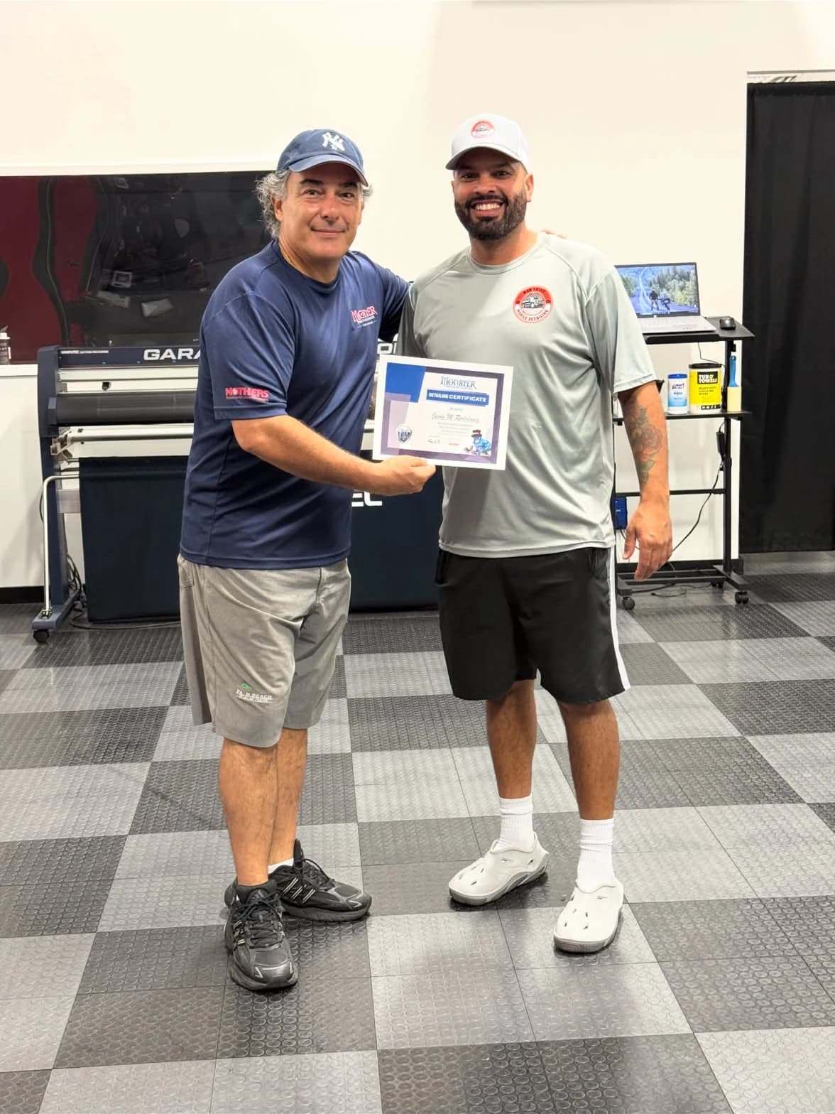Rod Shine owner holding his detailing training certificate with his instructor