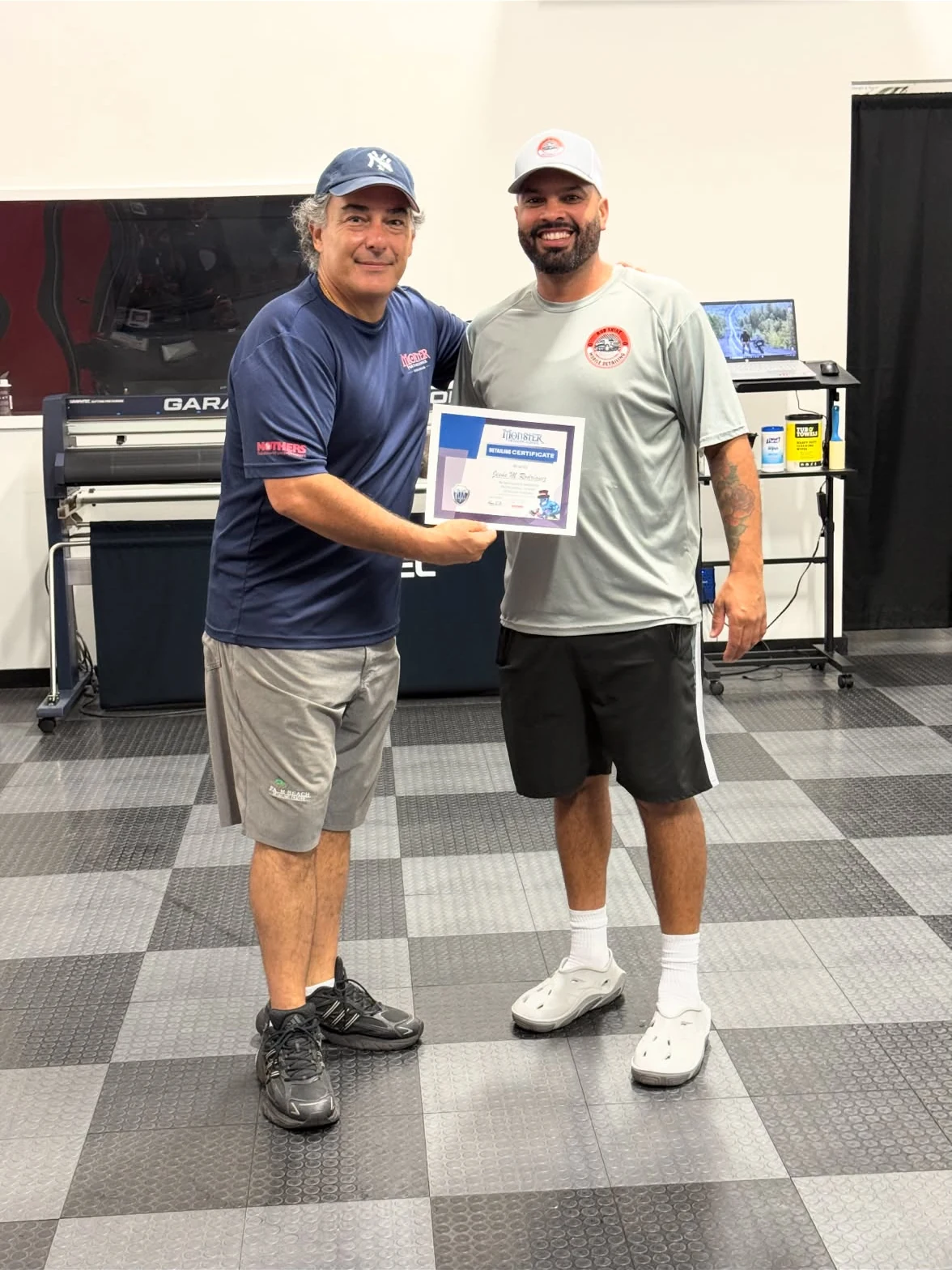 Rod Shine owner holding a detailing training certificate
