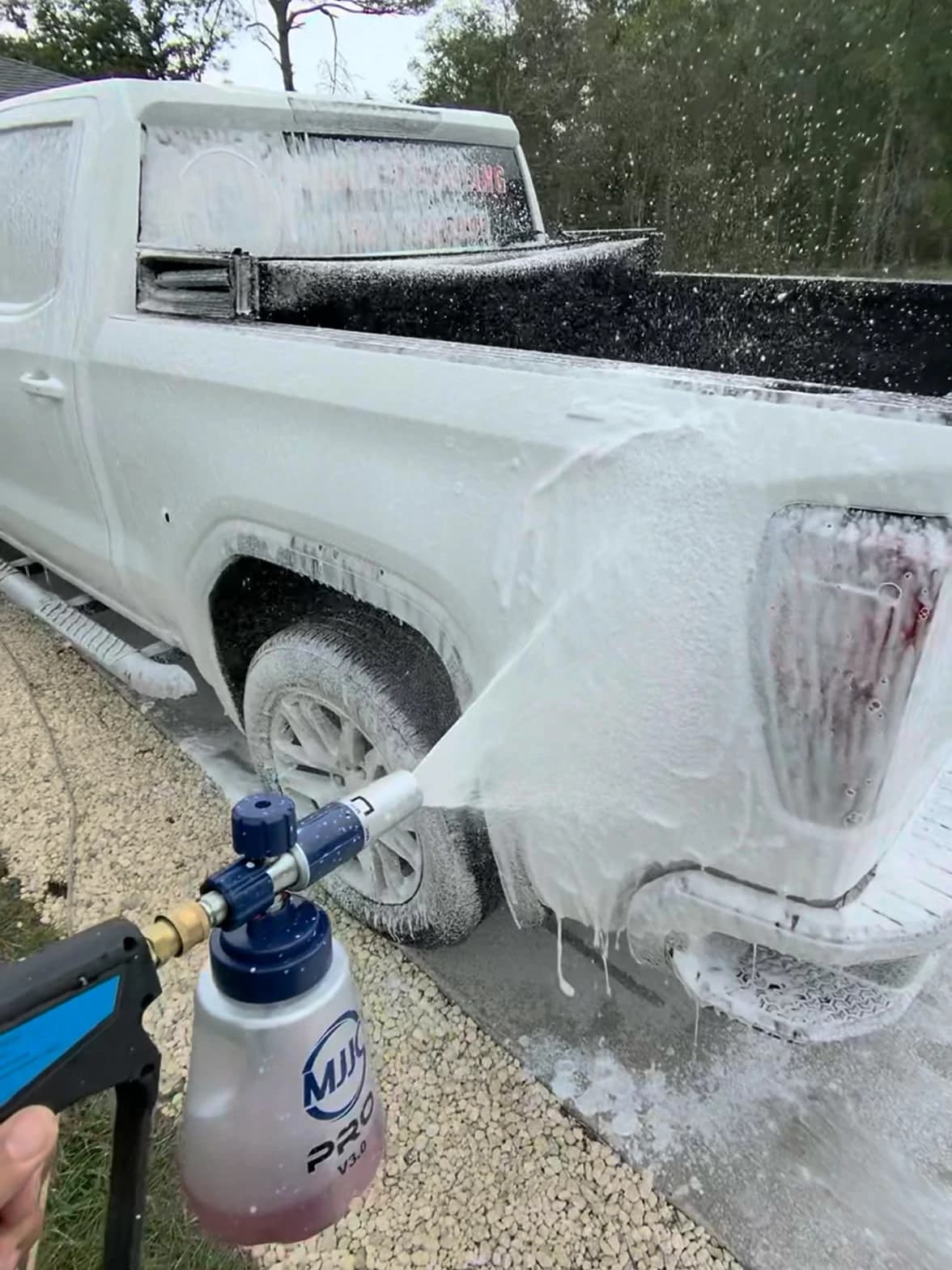 Foam wash covering a white pickup during Rod Shine exterior detailing