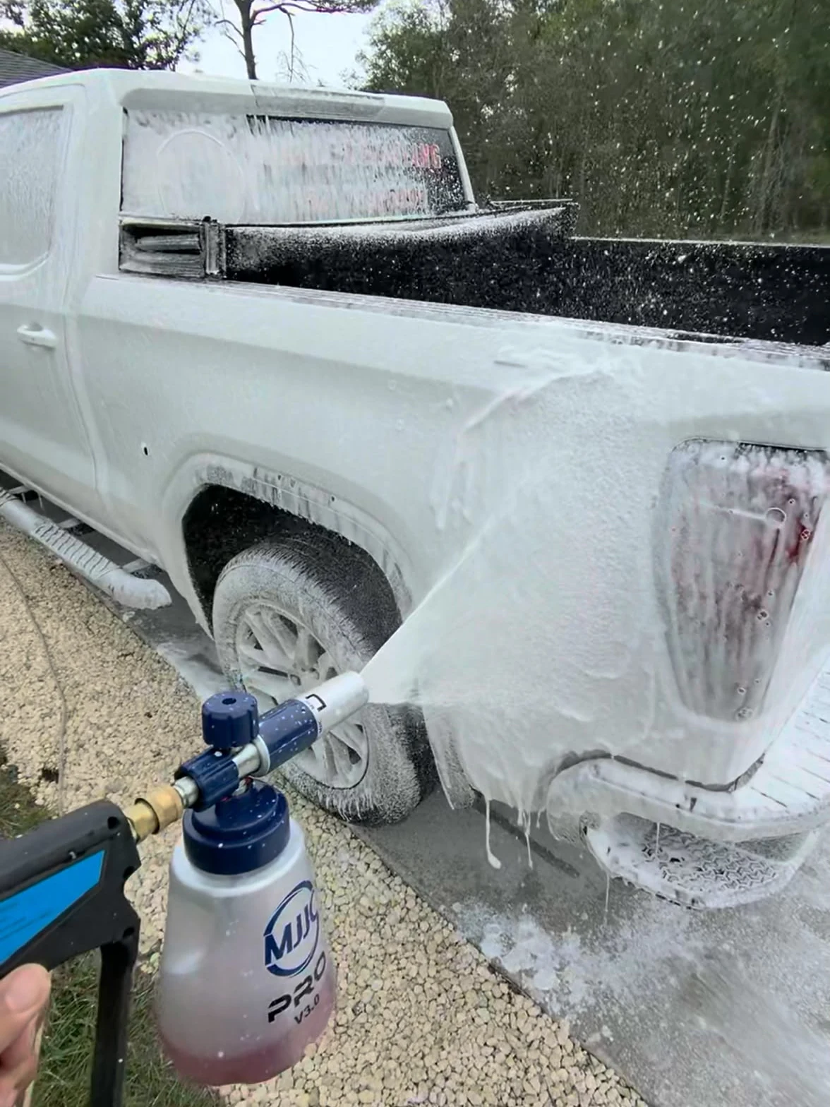 White pickup covered in foam during Rod Shine exterior detailing