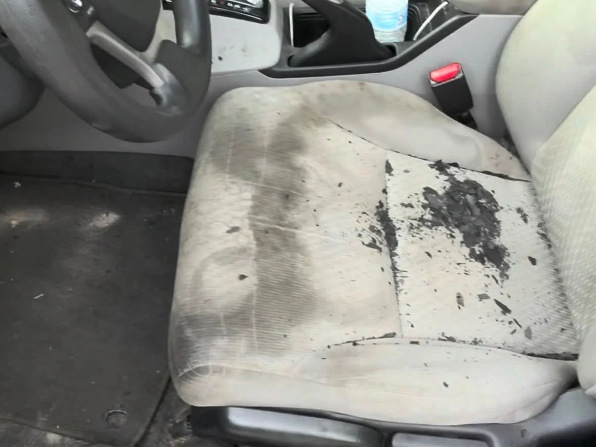 Heavily soiled Honda cloth seat before detailing